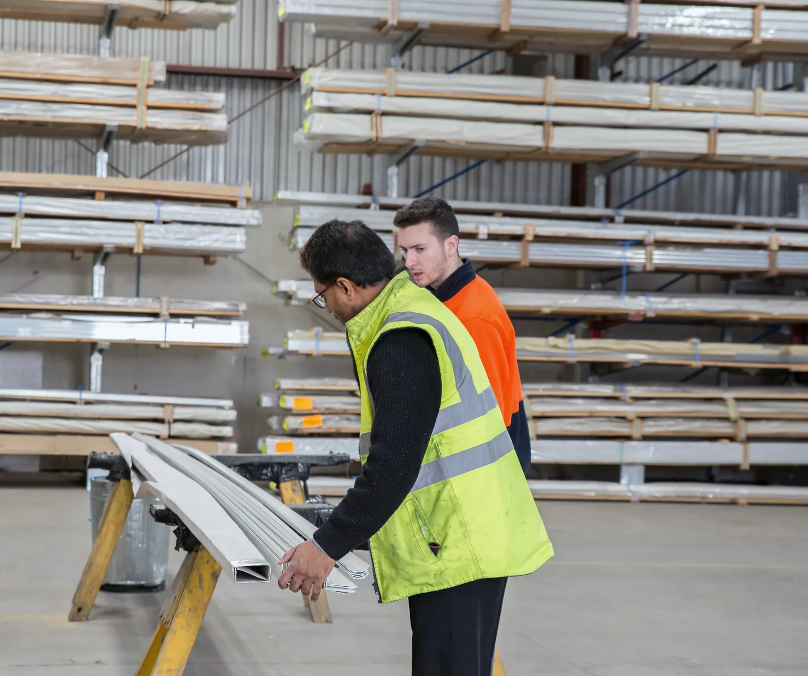 Supervisor observing a warehouse worker handling materials